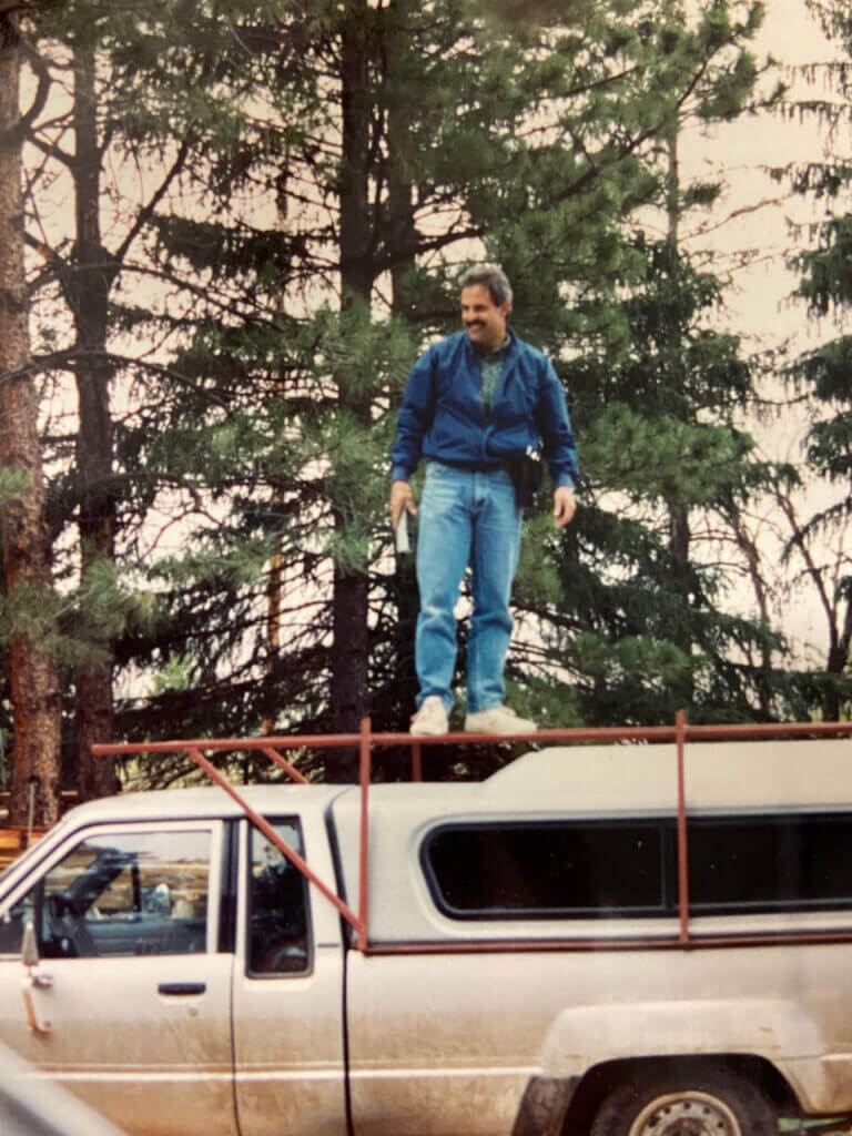 Paul Hockersmith standing on a work truck.